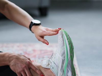Hands touching toes in a stretching exercise.